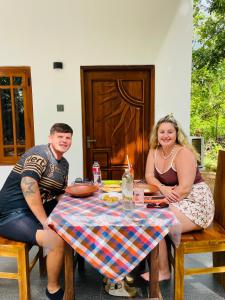 a man and a woman sitting at a table at Royal Breeze Resort Sigiriya in Sigiriya