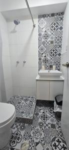 a bathroom with a white toilet and a sink at Yanahuara HOTEL PLAZA in Yanahuara