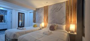 a hotel room with two beds and two lamps at Yanahuara HOTEL PLAZA in Yanahuara +29 photos