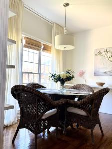 a dining room table with chairs and a vase of flowers at Modern Southern Comfort in Bowling Green