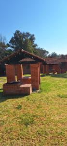 a small building in the middle of a field at Cabañas cipreses in San Miguel Regla