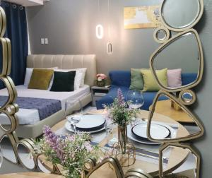 a living room with a couch and a table with a mirror at Elite Pod Manila in Manila +41 photos