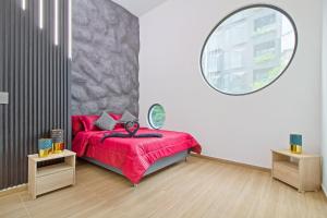 a bedroom with a red bed and a large mirror at Massive Jacuzzi - 6 Bedroom with Private Bathroom - 1 block from LLeras P11 in Medellín