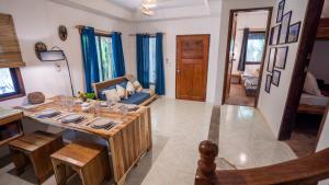 a living room with a table and a couch at Manta House - Villa in Town in El Nido +31 photos