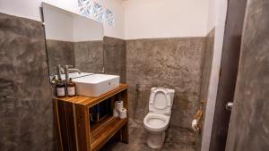 a bathroom with a sink and a toilet at Manta House - Villa in Town in El Nido
