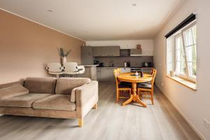 a living room with a couch and a table at Vestre apartment in Ålesund