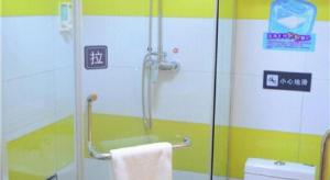una ducha con puerta de cristal en un baño en 7 Days Inn Enshi Xueyuan Road Shinan Ancient City, en Enshi