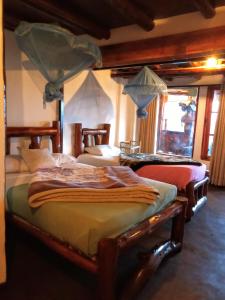 a bedroom with three beds in a room at The Paulwood cabana home stay in Nuwara Eliya