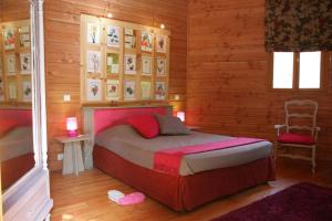 a bedroom with a bed and a chair in it at le refuge des pots rouges in Cros