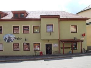 a woman standing in the doorway of a building at Apartment Ortler in Banská Štiavnica