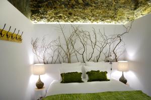 a bedroom with a white bed with two lamps at Sparrow Sintra Nest in Sintra