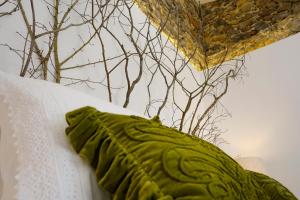 a green pillow sitting on top of a table at Sparrow Sintra Nest in Sintra