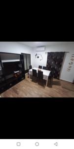 a living room with a table and chairs and a television at La Casita de Martina in Sotillo de la Adrada