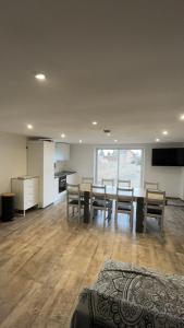 a living room with a dining room table and chairs at Hébergement curgy in Curgy