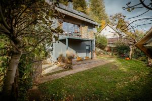 a house with a porch on the side of it at Modern Chalet With Sauna Near Thuringian Forest in Zella-Mehlis