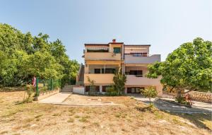 a building with trees in front of it at 1 Bedroom Lovely Apartment In Potocnica in Borovići