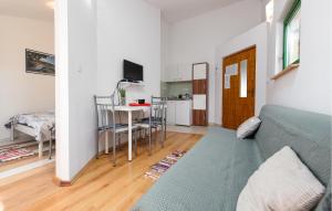 a living room with a couch and a table and a kitchen at 1 Bedroom Lovely Apartment In Potocnica in Borovići