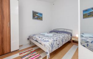 a bedroom with a bed and a mirror at 1 Bedroom Lovely Apartment In Potocnica in Borovići
