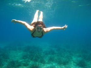 a woman is swimming in the water at Kerveli Luxury Villa in Kerveli