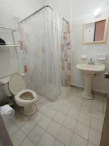 a bathroom with a toilet and a sink at Connected House in Torreón in Torreón +45 photos