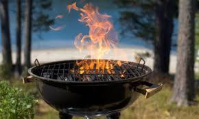 a bbq grill with fire on it in a field at Azzurromare Residence in Procida