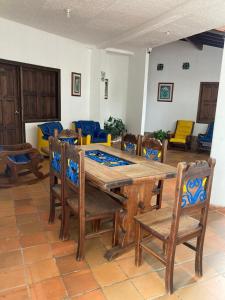 a dining room with a wooden table and chairs at Hotel Campestre Villa Lucila in San Gil