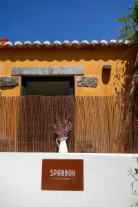 a vase on top of a building with a window at Sparrow Sintra Nest in Sintra