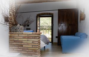 a living room with a brick fireplace and a bed at Il Nido di Rondine in Dolceacqua