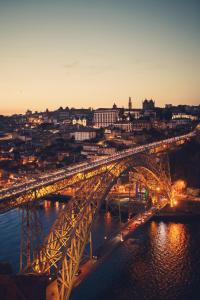 a bridge over a river with traffic on it at Apartamento LM Ribeira in Porto