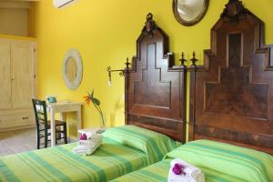 A bed or beds in a room at La Fattoria Delle Tartarughe