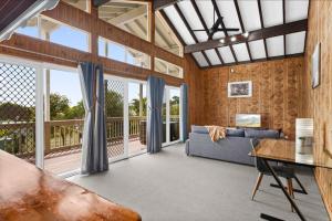 a living room with a couch and a table at Loftus Spacious Getaway in Barrack Point