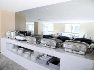 a large kitchen with many pans and plates on a counter at Lavande Hotel Shenzhen North Station Huawei Gangtou Metro Station in Tiantangwei