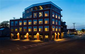 a tall building on a city street at night at 250 Main Hotel in Rockland +21 photos