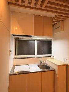a small kitchen with a sink and a window at 東福寺2 都憶 in Kyoto