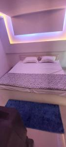 a bedroom with a bed with a blue rug at The Krishnam Resort in Mādho Tānda