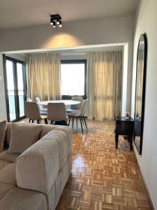 a living room with a couch and a table at Kallisti 1bd Central Stay - Wow View in Nicosia