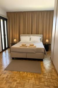 a bedroom with a bed with two towels on it at Kallisti 1bd Central Stay - Wow View in Nicosia