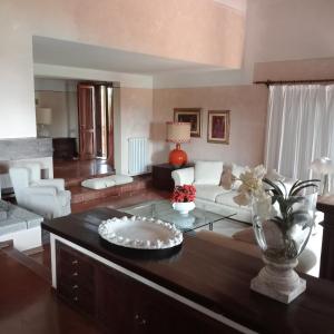 a living room with a couch and a table at Villa Ines with pool and Jacuzzi hot tube in Terranuova Bracciolini