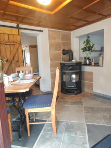 a dining room with a table and a stove at Veronika in Wesenberg +16 photos
