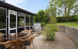 a patio with a table and chairs and a building at Awesome Home In Kirke Såby With Wifi in Kirke Såby