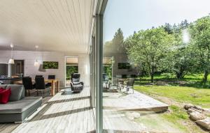 a patio with a couch and chairs and a table at Lovely Home In Ruhla With Sauna in Ruhla +4 photos