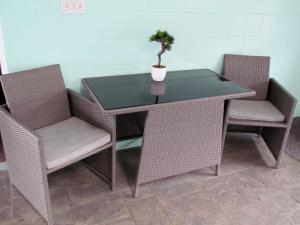 a table with two chairs and a potted plant on it at Slumber Lodge in Hope