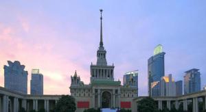 a building with a spire in the middle of a city at GreenTree Inn Shanghai South Railway Station Xujiahui Stadium Subway Station Shell Hotel in Shanghai