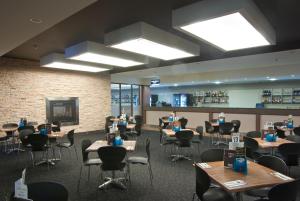 a dining room with tables and chairs at Brighton Hotel Motel in Pontville