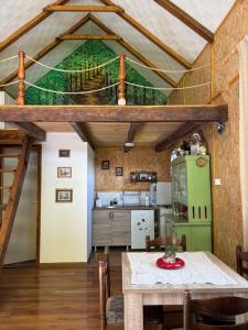 a kitchen with a table and a green refrigerator at Zasavčanka in Sremska Mitrovica
