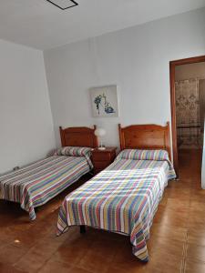 Postel nebo postele na pokoji v ubytování Apartamentos Nelly