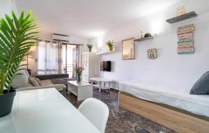 a bedroom with a bed and a living room at Gorgeous Apartment In Fuengirola in Fuengirola