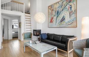 a living room with a couch and a table at Stunning Home In Bogense in Bogense