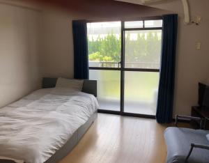Postel nebo postele na pokoji v ubytování 豊前市国際交流会館
