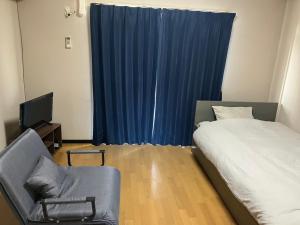 Postel nebo postele na pokoji v ubytování 豊前市国際交流会館